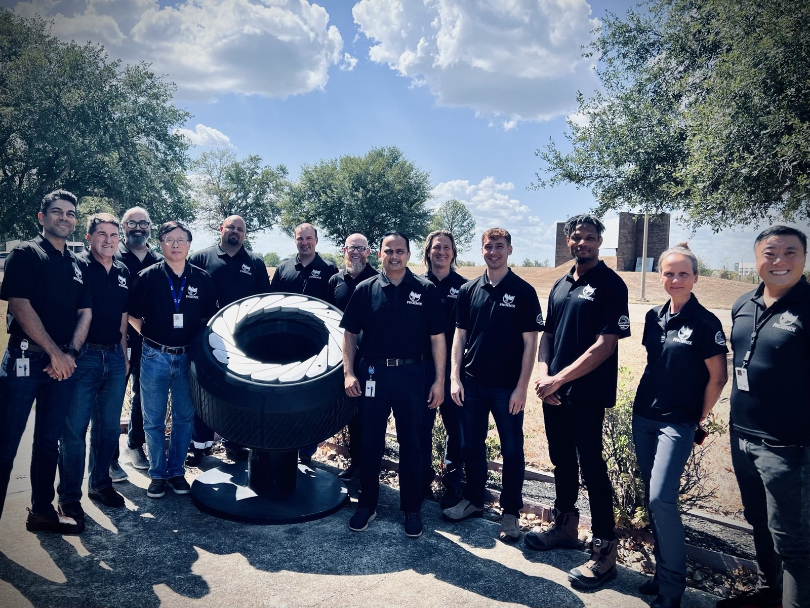 Luke Dupree with an industrial engineering team next to production hardware